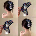 Chinese embroidered bow hair claw clip worn in bun hairstyle - multiple angles